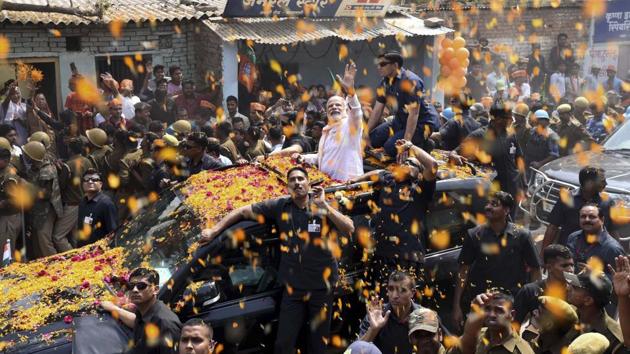 Enthusiastic supporters lined to get a glimpse of Prime Minister Narendra Modi during his road show in Varanasi on March 4th. (Arun Sharma/HT PHOTO)