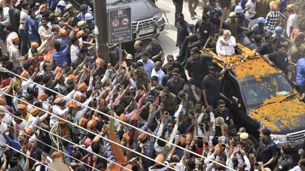 Prime Minister Narendra Modi waves at enthusiastic supporters during his Varanasi road show on March 4th (Arun Sharma/HT PHOTO)