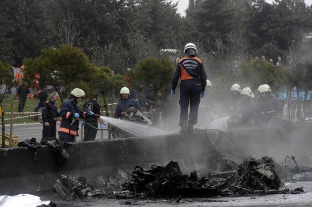 Firefighters at the site of the crash on Friday.(AP)