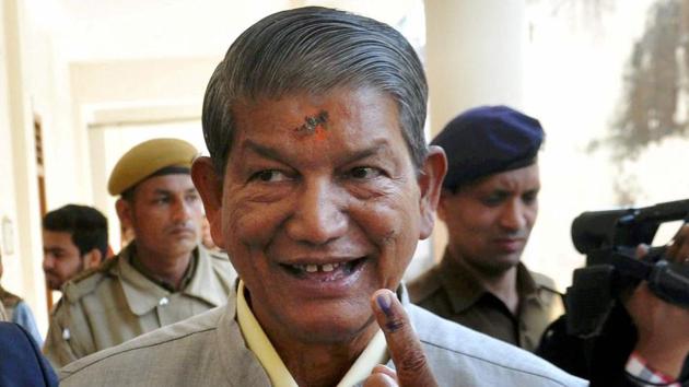 Uttarakhand chief minister Harish Rawat gestures with his inked finger after casting vote at Dharampur constituency in Dehradun(PTI)