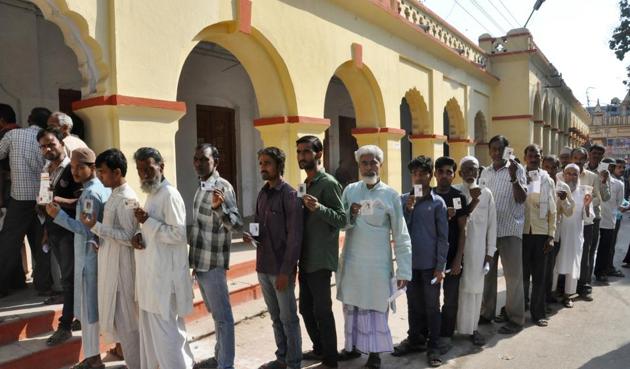 People wait in queue to caste their vote for Assembly elections, in Varanasi.(HT Archive)