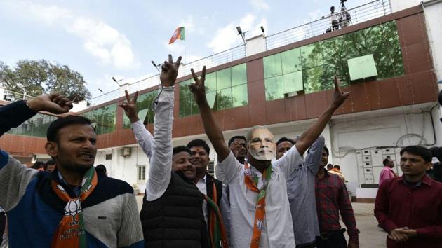 BJP workers celebrate outside their office in Lucknow after elections results showed leading in Uttar Pradesh.(HT Photo/Arvind Yadav)