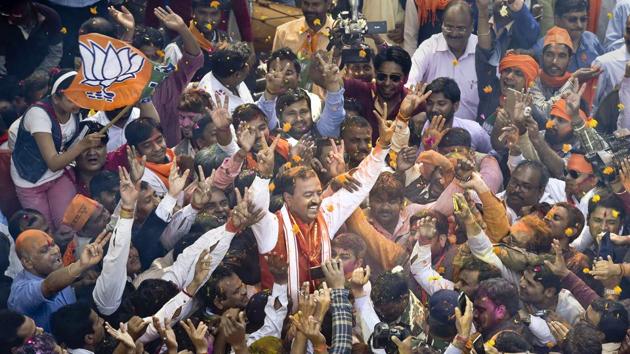 Uttar Pradesh state president Keshav Prasad Maurya and BJP workers celebrate the victory after declaration of results at the party office in Lucknow. (Arvind Yadav/HT PHOTO) 