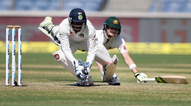 India’s Wriddhiman Saha in action against Australia in the first Test match in Pune.(AFP)
