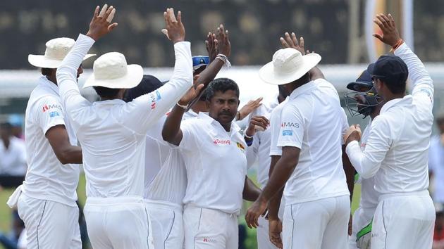 Sri Lankan cricket team players congratulate Rangana Herath (centre) after he dismissed Bangladesh national cricket team player Liton Das during the final day of the first Test at the Galle International Cricket Stadium on Saturday(AFP)