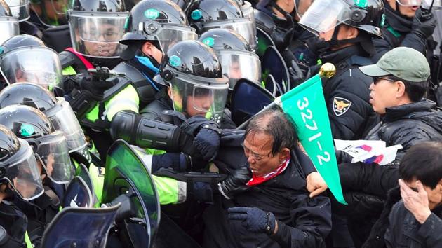South Korean supporters of Park Geun-Hye clash with police after the announcement of the Constitutional Court over the impeachment of South Korea's President Park Geun-Hye in Seoul on March 10, 2017.(AFP) South Korean supporters of Park Geun-Hye clash with police after the announcement of the Constitutional Court over the impeachment of South Korea's President Park Geun-Hye in Seoul on March 10, 2017.(AFP)