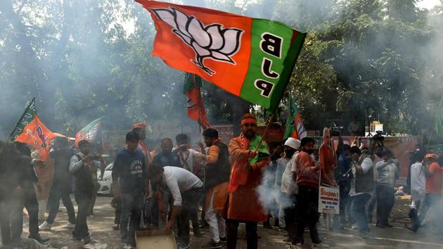 Bhartiya Janata Party (BJP) supporters celebrate elections results outside the party headquarters in New Delhi on Saturday as PM Narendra Modi looked set to tighten his grip on power with early trends showing his party leading in the key battleground of Uttar Pradesh.(AFP) Bhartiya Janata Party (BJP) supporters celebrate elections results outside the party headquarters in New Delhi on Saturday as PM Narendra Modi looked set to tighten his grip on power with early trends showing his party leading in the key battleground of Uttar Pradesh.(AFP)