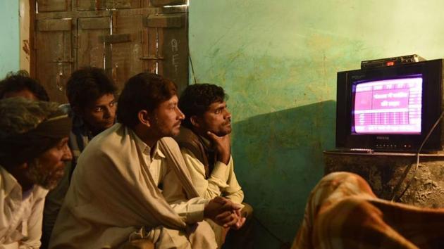 People in Jogayi Khera in Muzaffarnagar watching UP election results on television.(Saumya Khandelwal/HT Photo) People in Jogayi Khera in Muzaffarnagar watching UP election results on television.(Saumya Khandelwal/HT Photo)