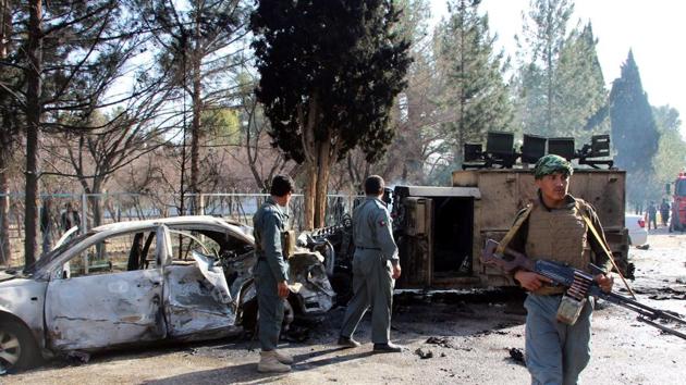 File photo of Afghan policemen inspecting a damaged army vehicle after a suicide attack in Lashkar Gah, Helmand province, Afghanistan February 11, 2017.(Reuters File)