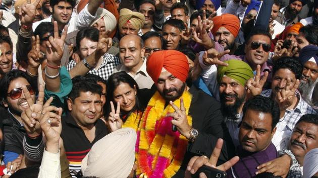 Amritsar MP Navjot Singh Sidhu along with his wife and newly elected BJP MLA from Amritsar east Navjot Kaur Sidhu celebrating the performance of their party in Punjab assembly polls on March 6, 2012 in Amritsar. (Munish Byala/ht photo)