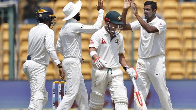 Ravichandran Ashwin, right, celebrates with teammates the dismissal of David Warner on Day 4 of the second India vs Australia Test in Bangalore on March 7, 2017.(AP)