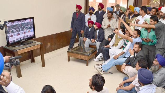 Supporters of SAD celebrating watching after election result on TV at the native home of the Badal family on March 6, 2012 in Badal, Punjab. Shiromani Akali Dal-BJP incumbent government in Punjab broke the Jinx by retaining power by winning 68 seats out 117 assembly seats. (Kulbir beera/ht Photo)