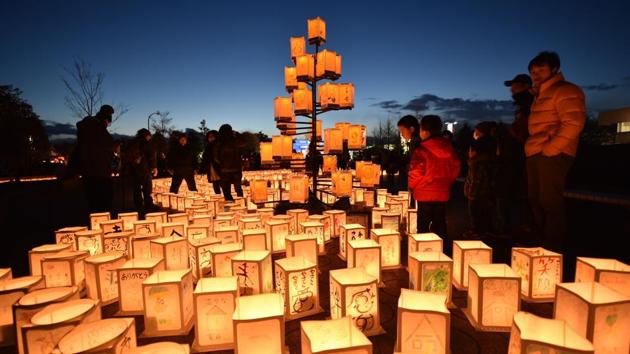 Visitors look at paper lanterns as part of a memorial service for victims of the 2011 quake-tsunami disaster in Natori, Miyagi prefecture on March 11, 2017. Japan is marking on March 11 the sixth anniversary of the magnitude 9.0 quake which struck under the Pacific Ocean and the ensuing tsunami which left about 18,500 people dead or missing. (KAZUHIRO NOGI / AFP) 