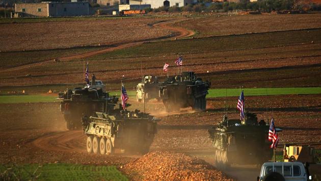 A convoy of US forces armoured vehicles drives near the village of Yalanli, on the western outskirts of the northern Syrian city of Manbij. (DELIL SOULEIMAN / AFP) 