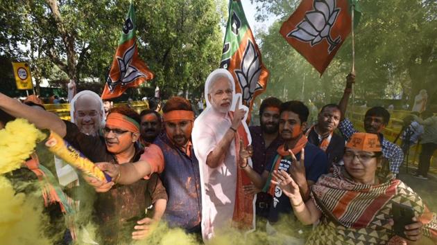 BJP workers celebrate outside the party headquarters in New Delhi on Sunday. (Raj K Raj/Hindustan Times) BJP workers celebrate outside the party headquarters in New Delhi on Sunday. (Raj K Raj/Hindustan Times)