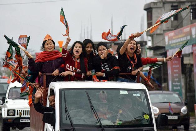 Supporters of BJP wave their flags as they celebrate their candidate win.The multi-phase elections across India, which began in February, ended on Wednesday, with results announced on March 11. (PTI) Supporters of BJP wave their flags as they celebrate their candidate win.The multi-phase elections across India, which began in February, ended on Wednesday, with results announced on March 11. (PTI)