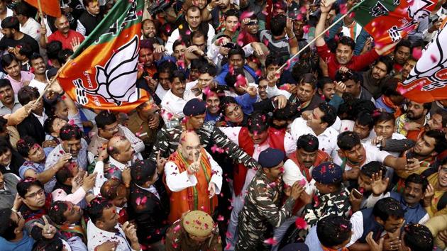 BJP President Amit Shah flashes victory sign at party workers who welcome him on his arrival at the party headquarters after party's win in Uttar Pradesh and Uttarakhand Assembly elections, in New Delhi on March 11.(PTI Photo)