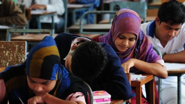 In this file photo clicked last year students are seen writing their papers for class 12 examination under Madhya Pradesh Board of Secondary Education at a centre in Bhopal(HT file photo for representational purpose)