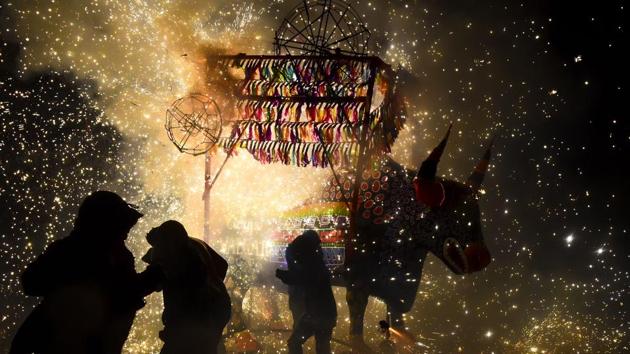 People run away from fireworks exploding around them next to a traditional ‘torito’ (little bull) -bull made of paper, wood and fireworks- during the celebration of San Juan de Dios festivity in Tultepec, in the outskirts of Mexico City . (RONALDO SCHEMIDT / AFP) People run away from fireworks exploding around them next to a traditional ‘torito’ (little bull) -bull made of paper, wood and fireworks- during the celebration of San Juan de Dios festivity in Tultepec, in the outskirts of Mexico City . (RONALDO SCHEMIDT / AFP)