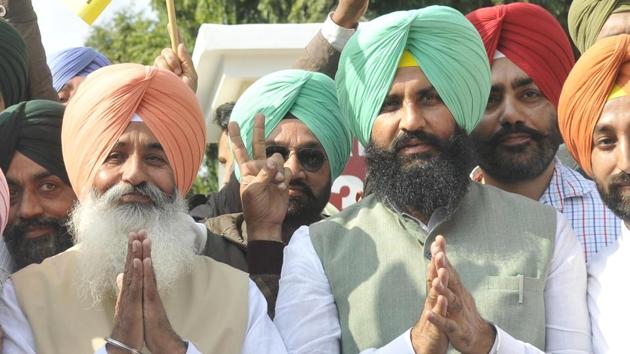 Lok Insaaf Party (LIP) candidates Balwinder Bains and Simarjit Singh Bains  celebrating their win with their supporters  in Ludhiana on Saturday. (/Gurminder Singh/HT Photo)