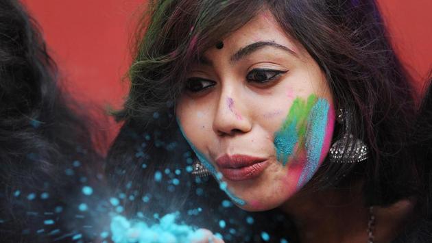 A student  blows colour powder during Holi, celebrations inside the university campus in Kolkata, India (Subhankar Chakraborty/HT PHOTO) 
