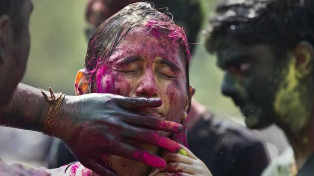 A woman shuts her eyes as coloured powder is smeared on her face during Holi celebration in Guwahati. (Anupam Nath / AP) A woman shuts her eyes as coloured powder is smeared on her face during Holi celebration in Guwahati. (Anupam Nath / AP)