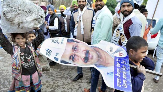 MISS THE CUT: Children carry a cutout of AAP leader Arvind Kejriwal at one of his road shows in Patiala for the Punjab assembly polls.(PTI file photo)