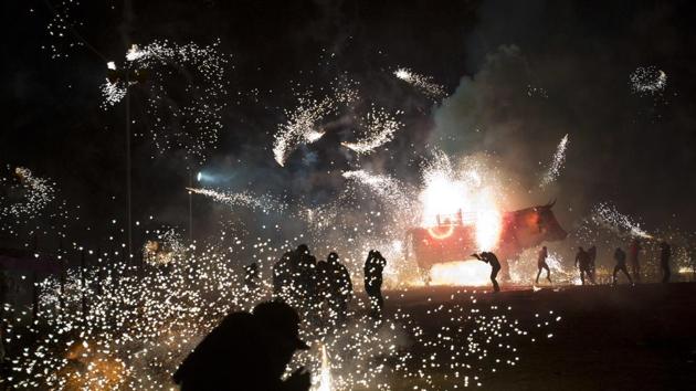 Fireworks explode off of a wheeled paper bull rigged with pyrotechnics during the annual pyrotechnics fair in Tultepec. (Rebecca Blackwell / AP) Fireworks explode off of a wheeled paper bull rigged with pyrotechnics during the annual pyrotechnics fair in Tultepec. (Rebecca Blackwell / AP)