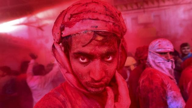 People of Barsana and Nandgaon at Radha Rani temple play Holi in Barsana. Nandgaon is the hometown of Radha, a close friend of Lord Krishna in Hindu mythology. According to the Holi tradition, the throwing of gulal originates with Radha and Lord Krishna. (Manvender Vashist / PTI) People of Barsana and Nandgaon at Radha Rani temple play Holi in Barsana. Nandgaon is the hometown of Radha, a close friend of Lord Krishna in Hindu mythology. According to the Holi tradition, the throwing of gulal originates with Radha and Lord Krishna. (Manvender Vashist / PTI)