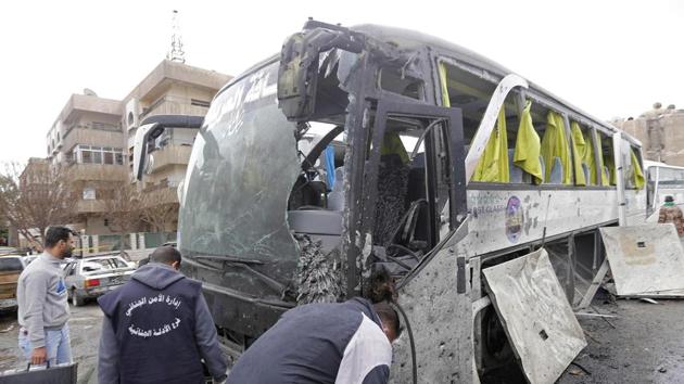 Syrian forensics examine a damaged bus at the scene of a bombing following twin attacks targeting Shiite pilgrims in Damascus' Old City on March 11. (AFP Photo) Syrian forensics examine a damaged bus at the scene of a bombing following twin attacks targeting Shiite pilgrims in Damascus' Old City on March 11. (AFP Photo)