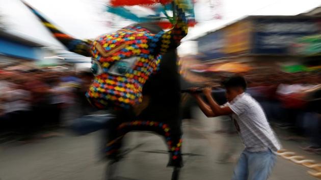 A man spins a traditional bull surrounded by fireworks, known as ‘Torito’, during the annual San Juan de Dios celebrations. (Carlos Jasso / REUTERS) A man spins a traditional bull surrounded by fireworks, known as ‘Torito’, during the annual San Juan de Dios celebrations. (Carlos Jasso / REUTERS)