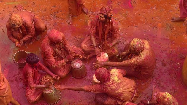 Men from the village of Nandgaon throw coloured powder at each other before joining a procession for the Lathmar Holi festival at the legendary hometown of Radha, consort of Hindu God Krishna, in Barsana. (Kamal Kishore / PTI) Men from the village of Nandgaon throw coloured powder at each other before joining a procession for the Lathmar Holi festival at the legendary hometown of Radha, consort of Hindu God Krishna, in Barsana. (Kamal Kishore / PTI)