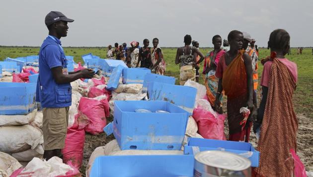 People collect food assistance on the outskirts of Mayom in South Sudan. South Sudanese rebels have kidnapped eight locals working for US charity Samaritan’s Purse.(AP File)