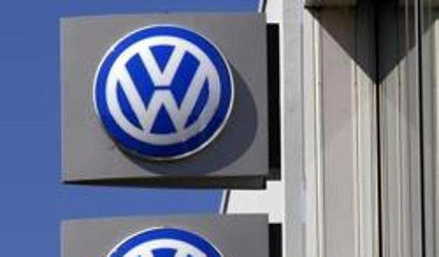 File photo of Volkswagen logos adorning a sign outside a dealership for the German automaker.(Reuters)