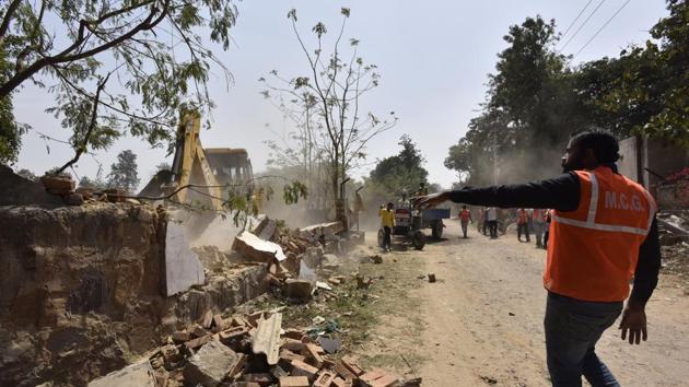 In a six-hour drive, MCG enforcement teams demolished some structures while taking possession of the disputed land at Gwal Pahari on Tuesday. (Sanjeev Verma/HT PHOTO) In a six-hour drive, MCG enforcement teams demolished some structures while taking possession of the disputed land at Gwal Pahari on Tuesday. (Sanjeev Verma/HT PHOTO)