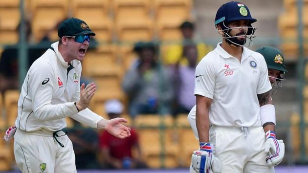 Virat Kohli looks on as Steve Smith celebrates his dismissal on Day 1 of the second Test at Chinnaswamy Stadium in Bangalore.(PTI)