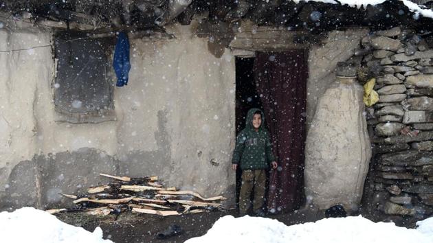 A Kashmiri boy looks on outside his mud house on the outskirts of Srinagar during a fresh snowfall on March 10, 2017. (AFP) A Kashmiri boy looks on outside his mud house on the outskirts of Srinagar during a fresh snowfall on March 10, 2017. (AFP)