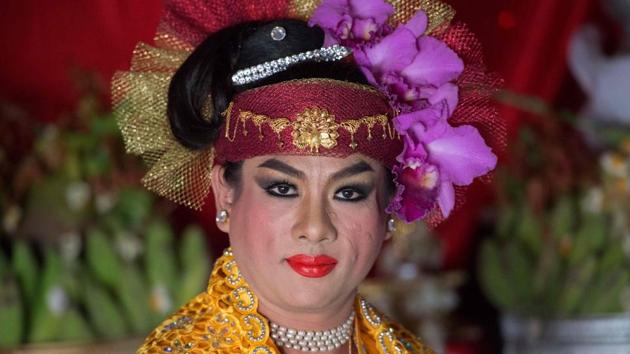 A medium poses for a photograph before beginning to invoke spirits inside a shrine in Shwe Ku Ni village. (Ye Aung Thu/AFP) A medium poses for a photograph before beginning to invoke spirits inside a shrine in Shwe Ku Ni village. (Ye Aung Thu/AFP)
