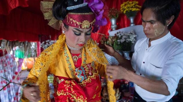 A medium gets dressed inside a shrine in Shwe Ku Ni village. (Ye Aung Thu/AFP) A medium gets dressed inside a shrine in Shwe Ku Ni village. (Ye Aung Thu/AFP)