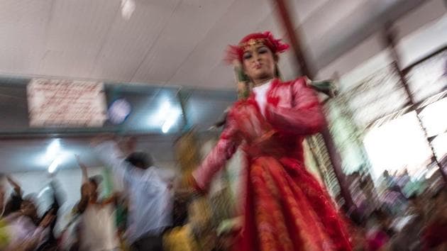 A medium smokes a cigarette as he invokes spirits inside a shrine in Shwe Ku Ni village during the Ko Gyi Kyaw Nat festival. (Ye Aung Thu/AFP) A medium smokes a cigarette as he invokes spirits inside a shrine in Shwe Ku Ni village during the Ko Gyi Kyaw Nat festival. (Ye Aung Thu/AFP)