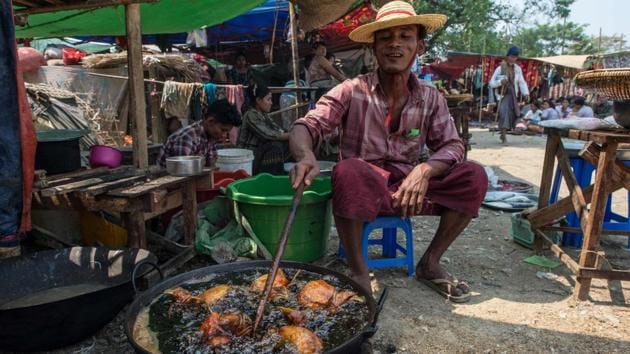 A man fries chicken in Shwe Ku Ni village to sell to devotees attending the Ko Gyi Kyaw Nat festival. Dozens of stalls sell his favourite food -- roast chicken -- to help sober up followers who overindulged in their whisky-fuelled worship. (Ye Aung Thu/AFP) A man fries chicken in Shwe Ku Ni village to sell to devotees attending the Ko Gyi Kyaw Nat festival. Dozens of stalls sell his favourite food -- roast chicken -- to help sober up followers who overindulged in their whisky-fuelled worship. (Ye Aung Thu/AFP)