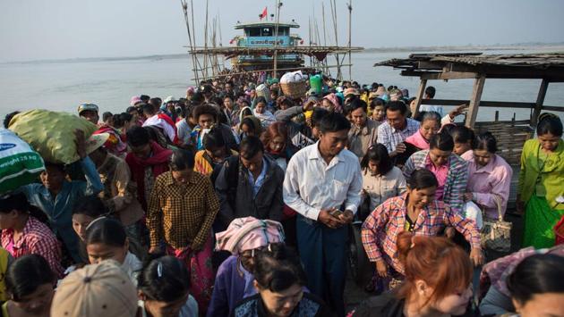 People disembark from a ferry on the banks of the Chindwin river in central Myanmar near Pakhangyi town as they head to participate in the Ko Gyi Kyaw Nat festival. Ko Gyi Kyaw is known for his penchant for booze, dancing and cockfights. (Ye Aung Thu/AFP) People disembark from a ferry on the banks of the Chindwin river in central Myanmar near Pakhangyi town as they head to participate in the Ko Gyi Kyaw Nat festival. Ko Gyi Kyaw is known for his penchant for booze, dancing and cockfights. (Ye Aung Thu/AFP)