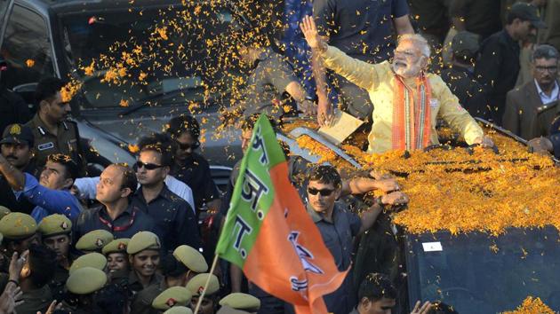 Prime Minister Narendra Modi waves at crowd during a road show in Varanasi on March 5. The BJP won the Uttar Pradesh assembly elections with a thumping majority.(Arun Sharma/HT Photo)