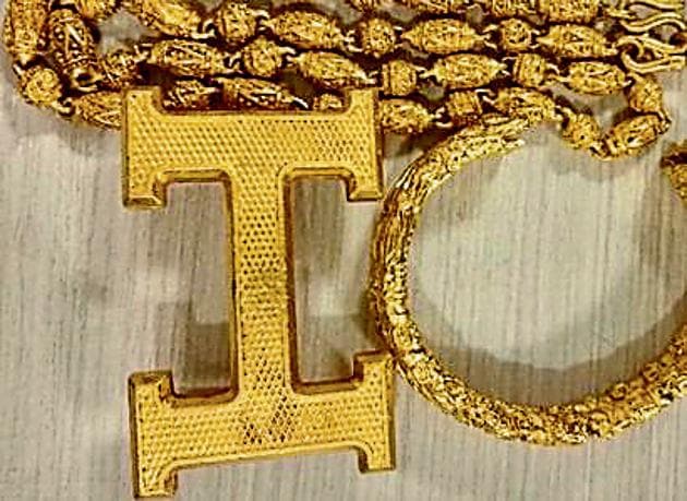 The AIU recovered gold chains with pendants of lord Buddha, buckles made of crude gold attached to the accused’s leather belts and crude rectangular gold plates depicting Tibetan deities, collectively weighing 6.176kg. (HT Photo) The AIU recovered gold chains with pendants of lord Buddha, buckles made of crude gold attached to the accused’s leather belts and crude rectangular gold plates depicting Tibetan deities, collectively weighing 6.176kg. (HT Photo)