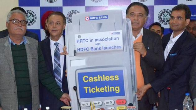 Himachal Pradesh transport minister GS Bali (second from right) during the cashless ticketing system launch event at Dharamshala on Wednesday.(HT Photo)