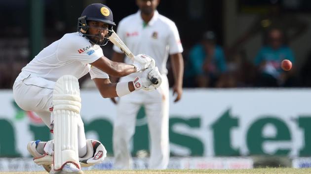 Sri Lanka cricket team’s Dinesh Chandimal hits a boundary during Day 1 of the second and final Test against Bangladesh national cricket team at P. Sara Oval in Colombo on Wednesday.(AFP)