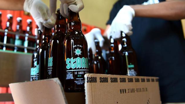 Workers at the Stark beer factory pack bottles of beer.(AFP)