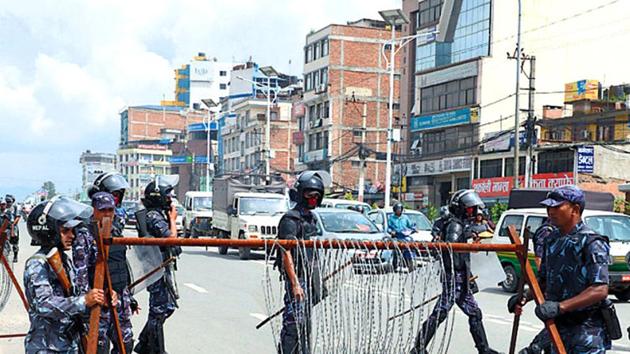 Police personnel block a road in Nepal. (AFP Photo) Police personnel block a road in Nepal. (AFP Photo)