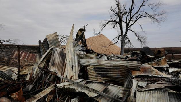 A fire extinguisher lies on the ground inside the remains of an equipment shed burned by wildfires near Lipscomb, Texas, U.S. (Lucas Jackson / REUTERS)