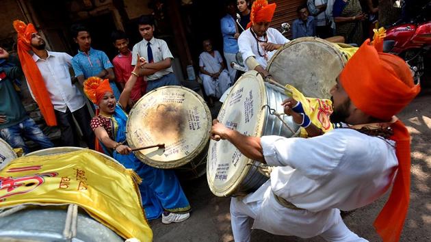 BEAT IT: Youngsters play drums during the procession. (Arijit Sen/HT Photo)